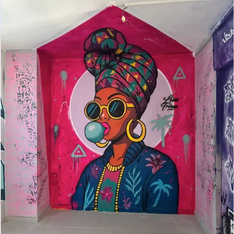 Fresque tropicale street art à La Réunion - portrait de femme avec cocotier par Lisa Trema